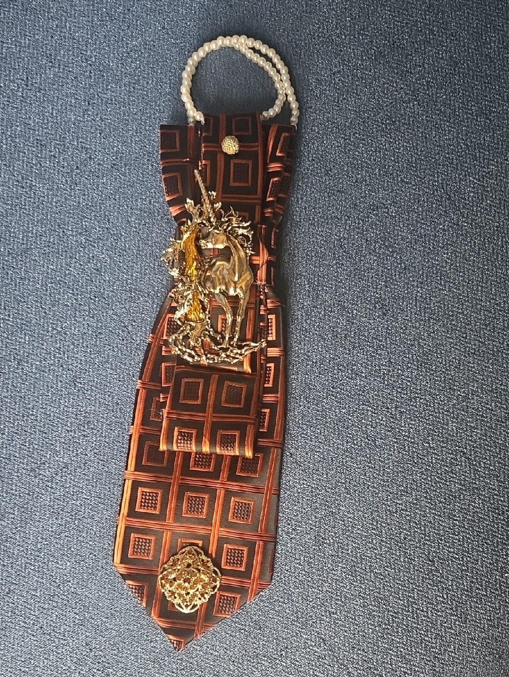 3/$60 Orange Black Geometric Cravat with Gold Toned Unicorn Detail